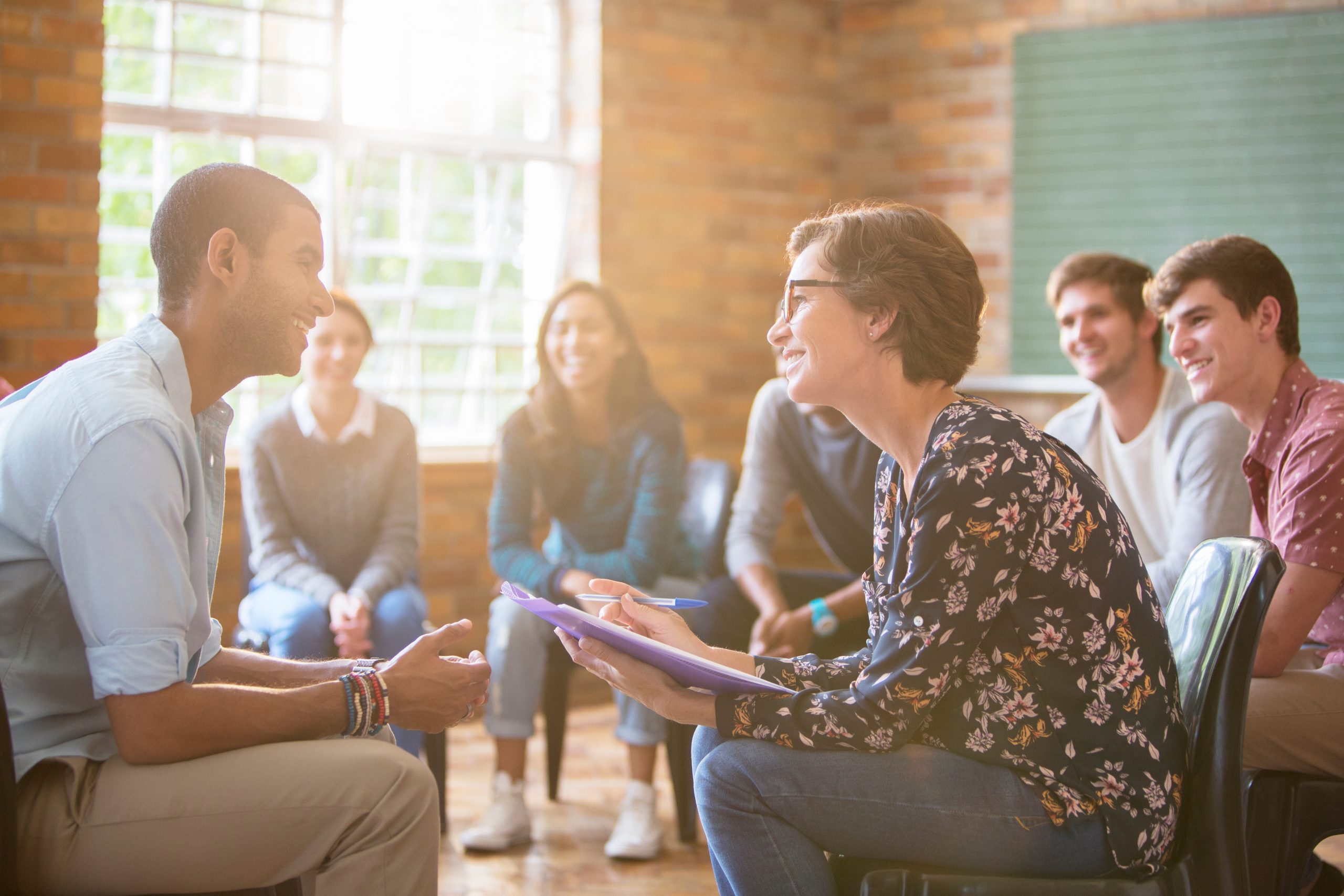 Group,Watching,Man,And,Woman,Talking,In,Group,Therapy,Session